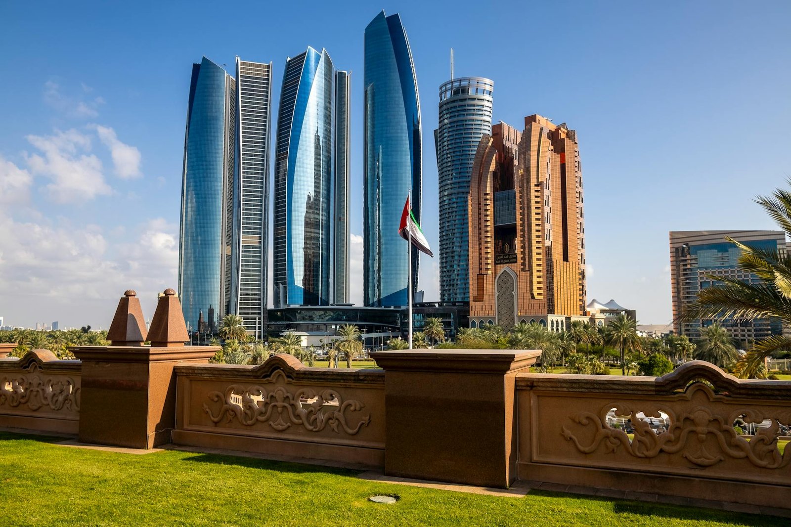 Stunning view of Abu Dhabi's Etihad Towers and city skyline under clear blue sky.