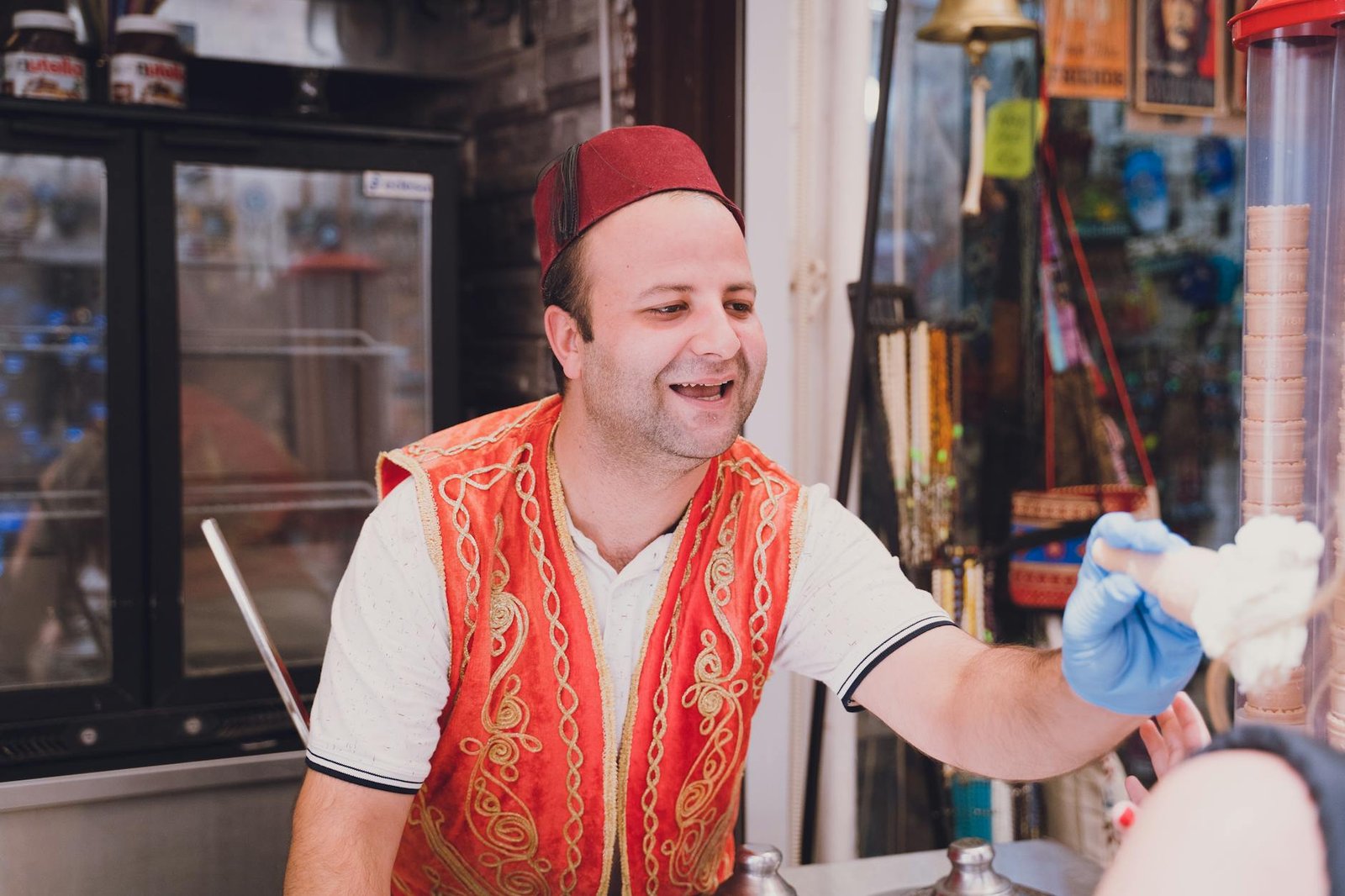 A cheerful Turkish man selling ice cream at a market stall in Bodrum, Turkey.