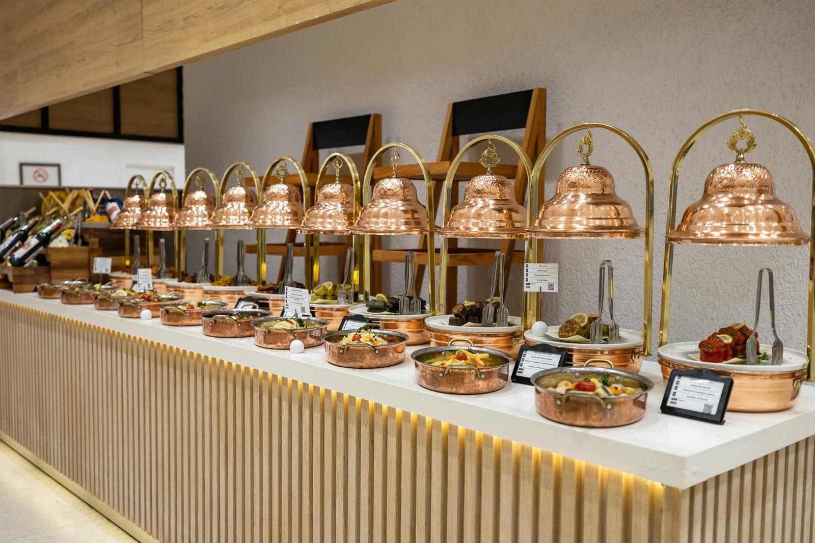 Luxurious buffet setup with copper dishes and elegant food presentation in Bodrum, Türkiye.
