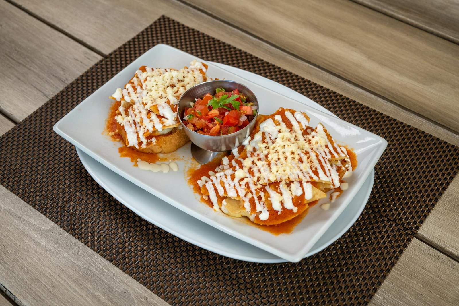Close-up of Mexican sopes topped with cheese and salsa, served at a restaurant in Salamanca, Mexico.