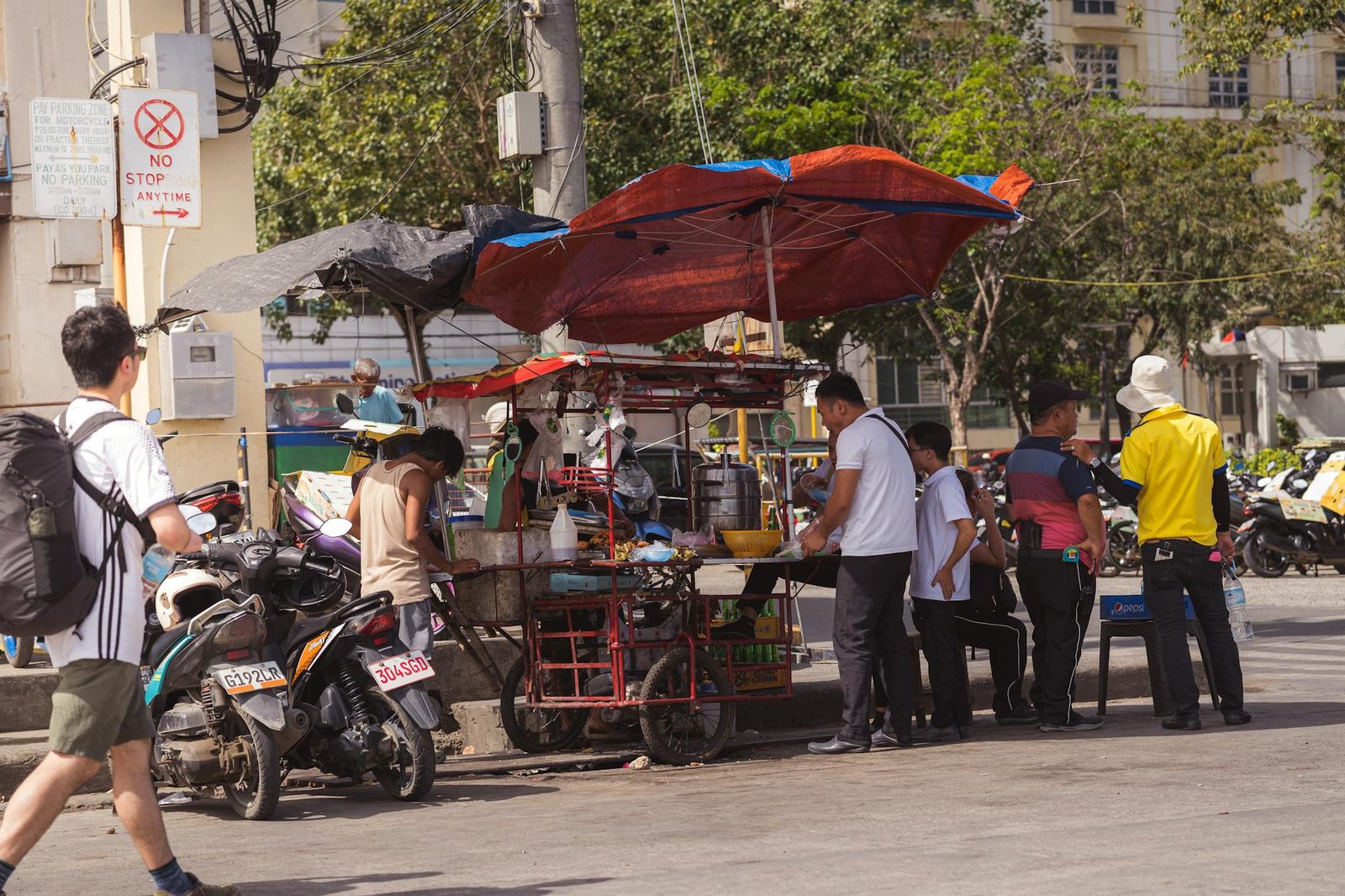 Street vendors serving food to locals in the bustling area of Cebu City, Central Visayas, Philippines.