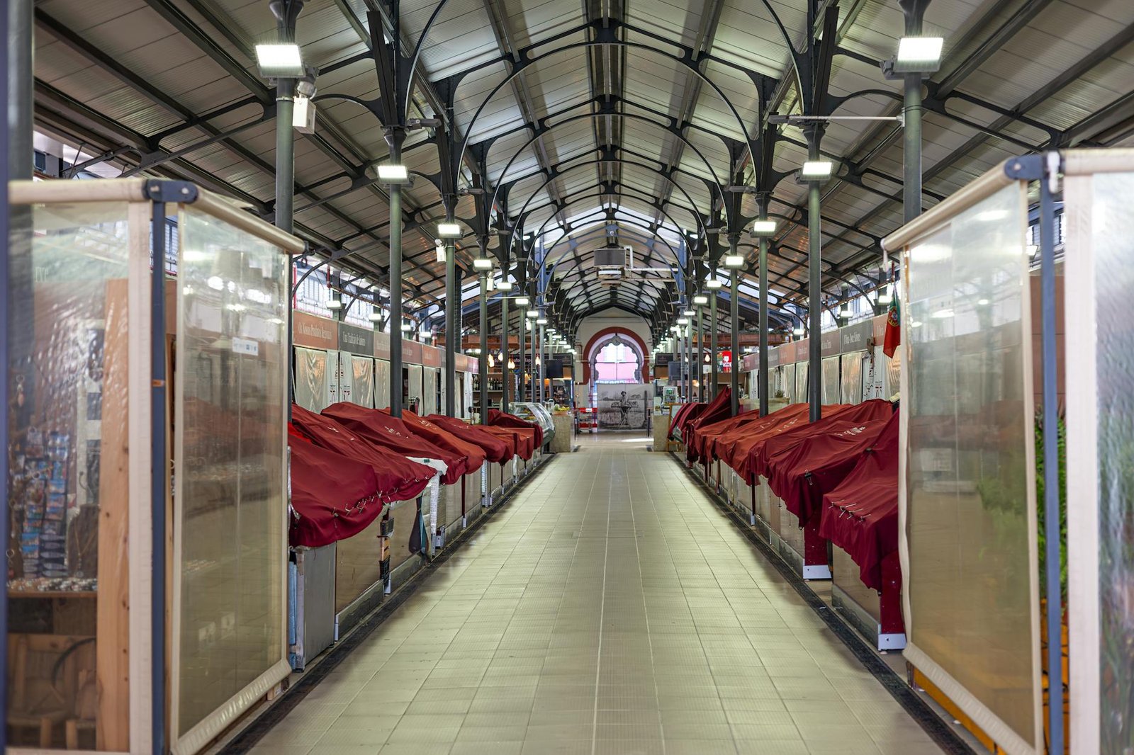 Explore the empty market hall in Loulé, Portugal, with its well-lit, arched interior.