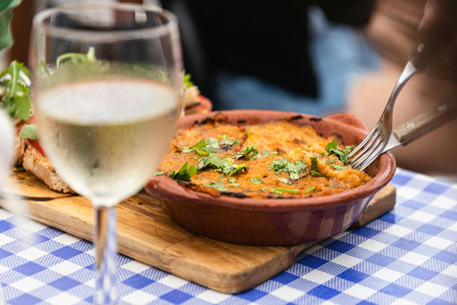 A delicious Portuguese dish served with white wine in a restaurant setting in Faro, Portugal.