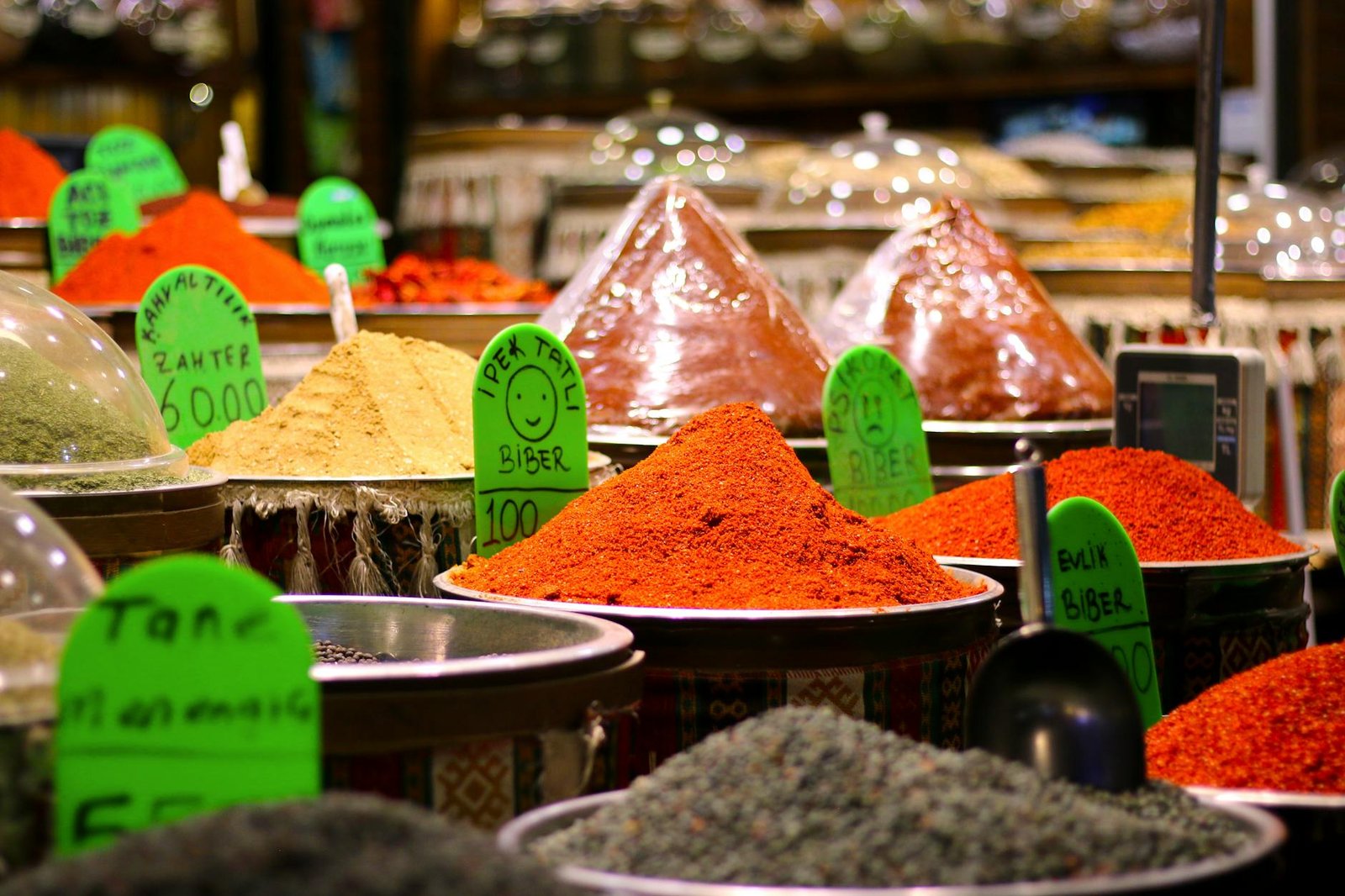 Colorful assortment of spices in Gaziantep market, featuring various chili powders and seasonings.