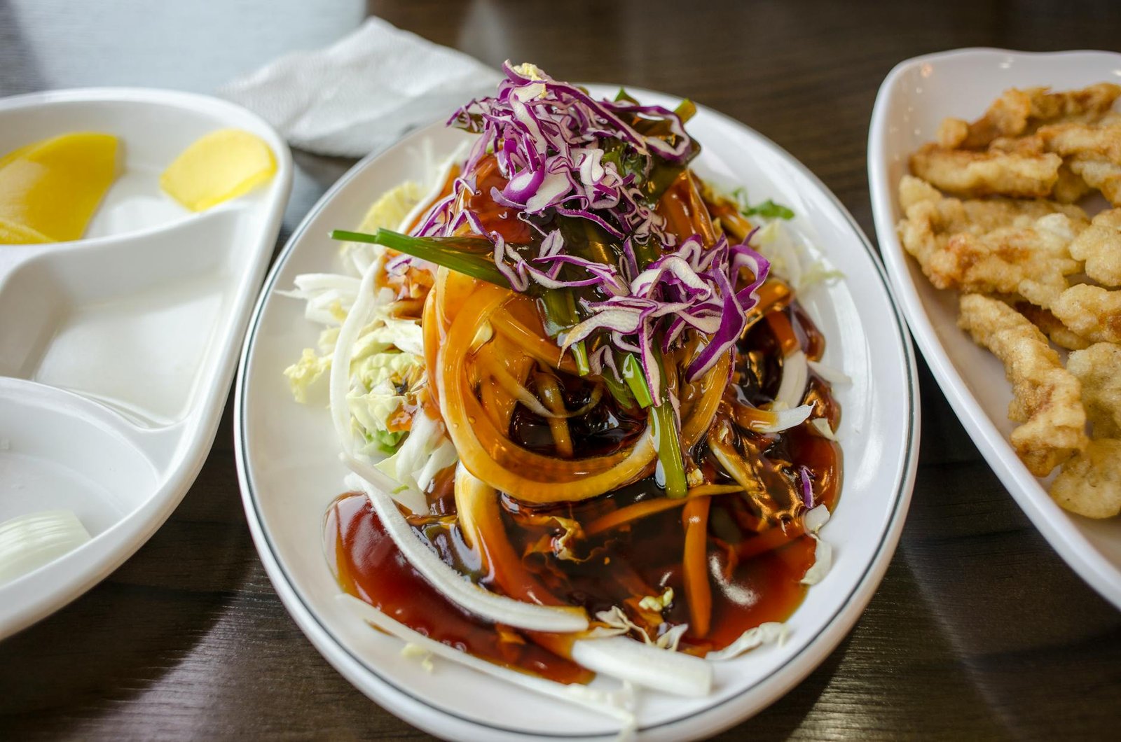 A delicious Asian salad with colorful vegetables and savory dressing on a table.