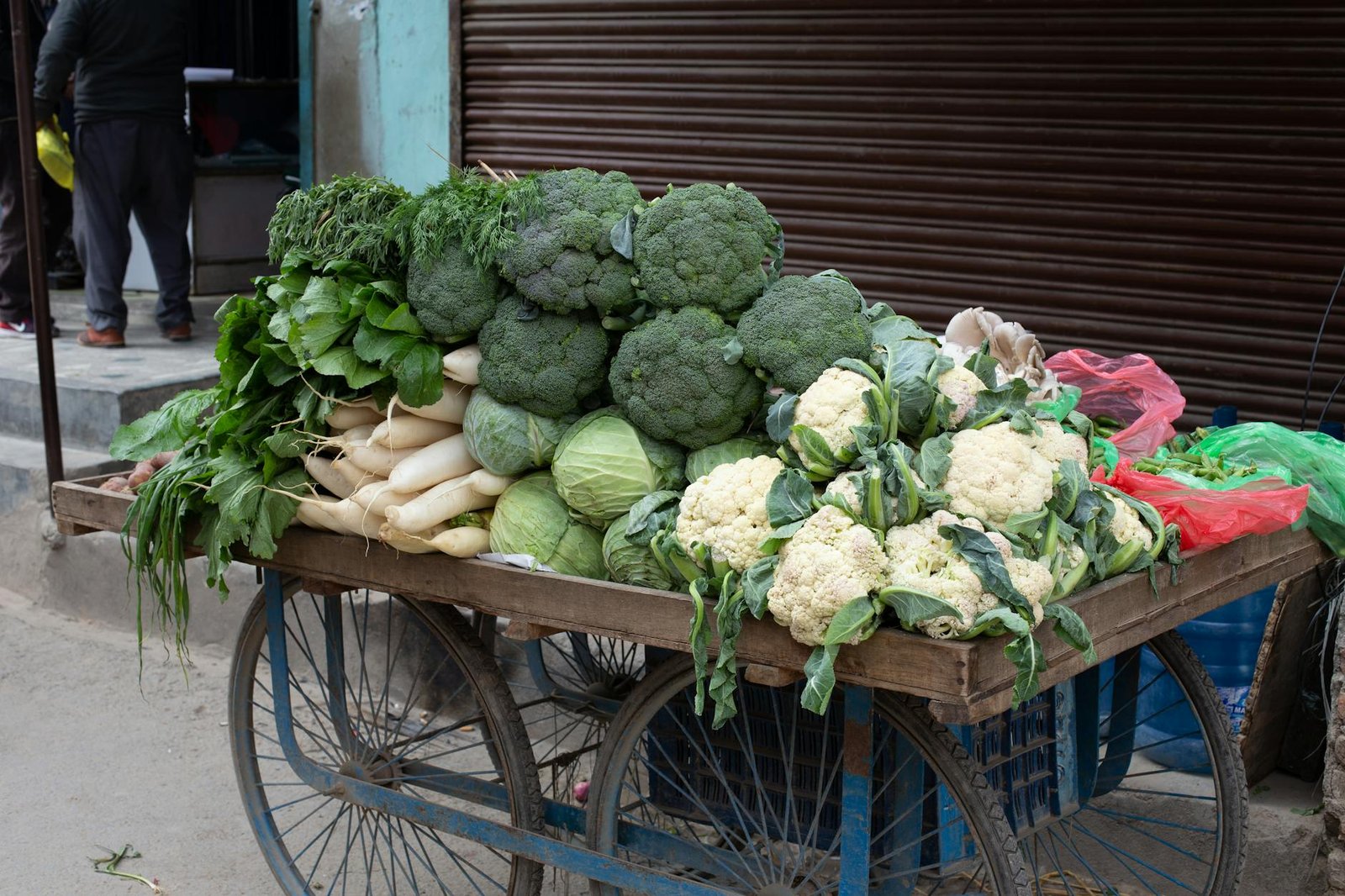 A variety of fresh vegetables displayed on a street cart in Kathmandu, Nepal.