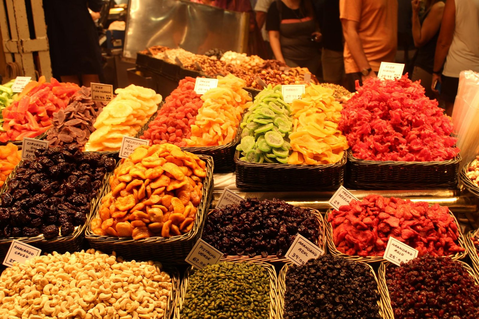 Colorful dried fruits on display at a market in Barcelona, showcasing a variety of flavors.