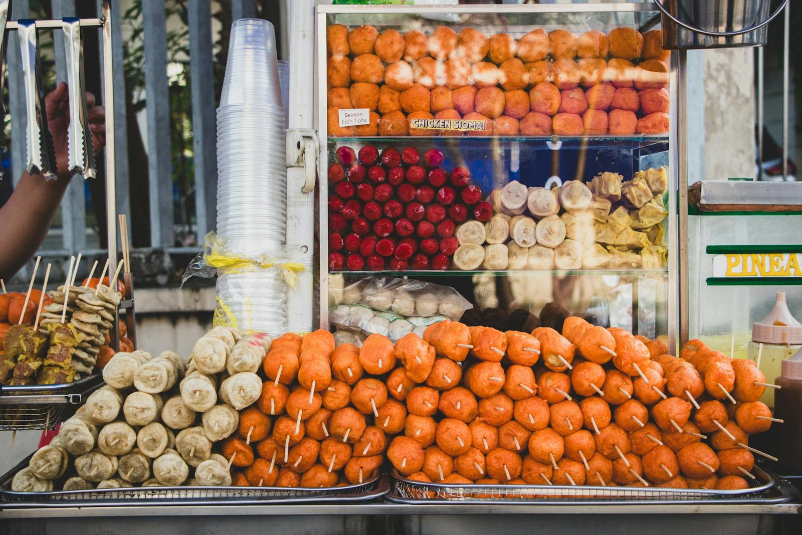 Street food stall featuring assorted Filipino snacks in Manila, Philippines.