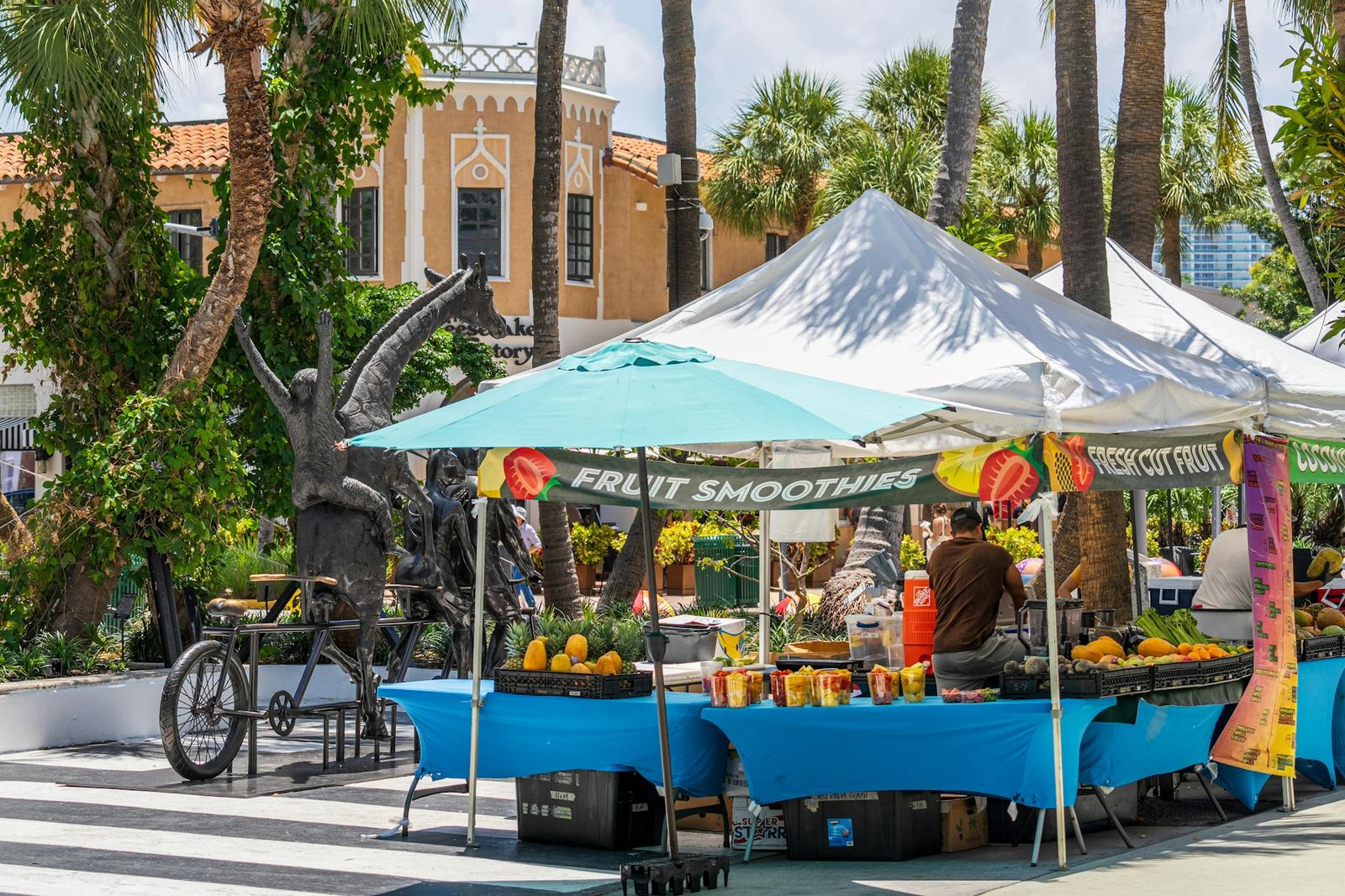 Fruit stalls under sunny skies in Miami Beach, featuring tropical produce and local art.