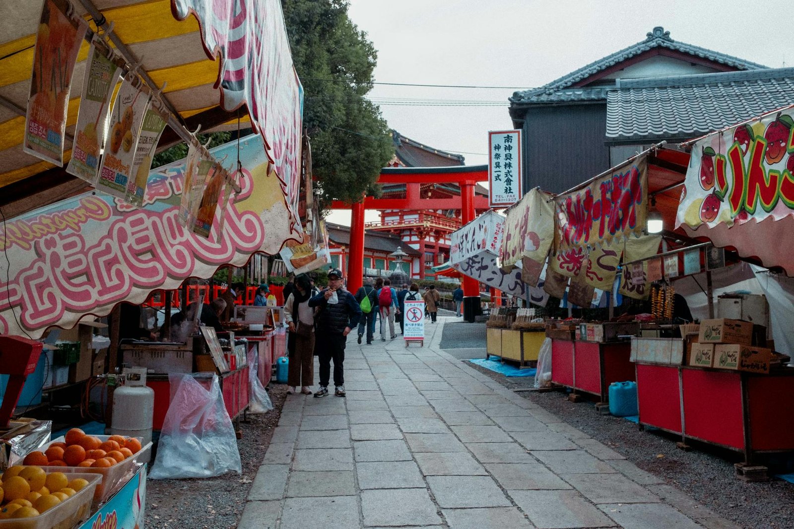 Vibrant Japanese market street with traditional stalls and colorful banners.