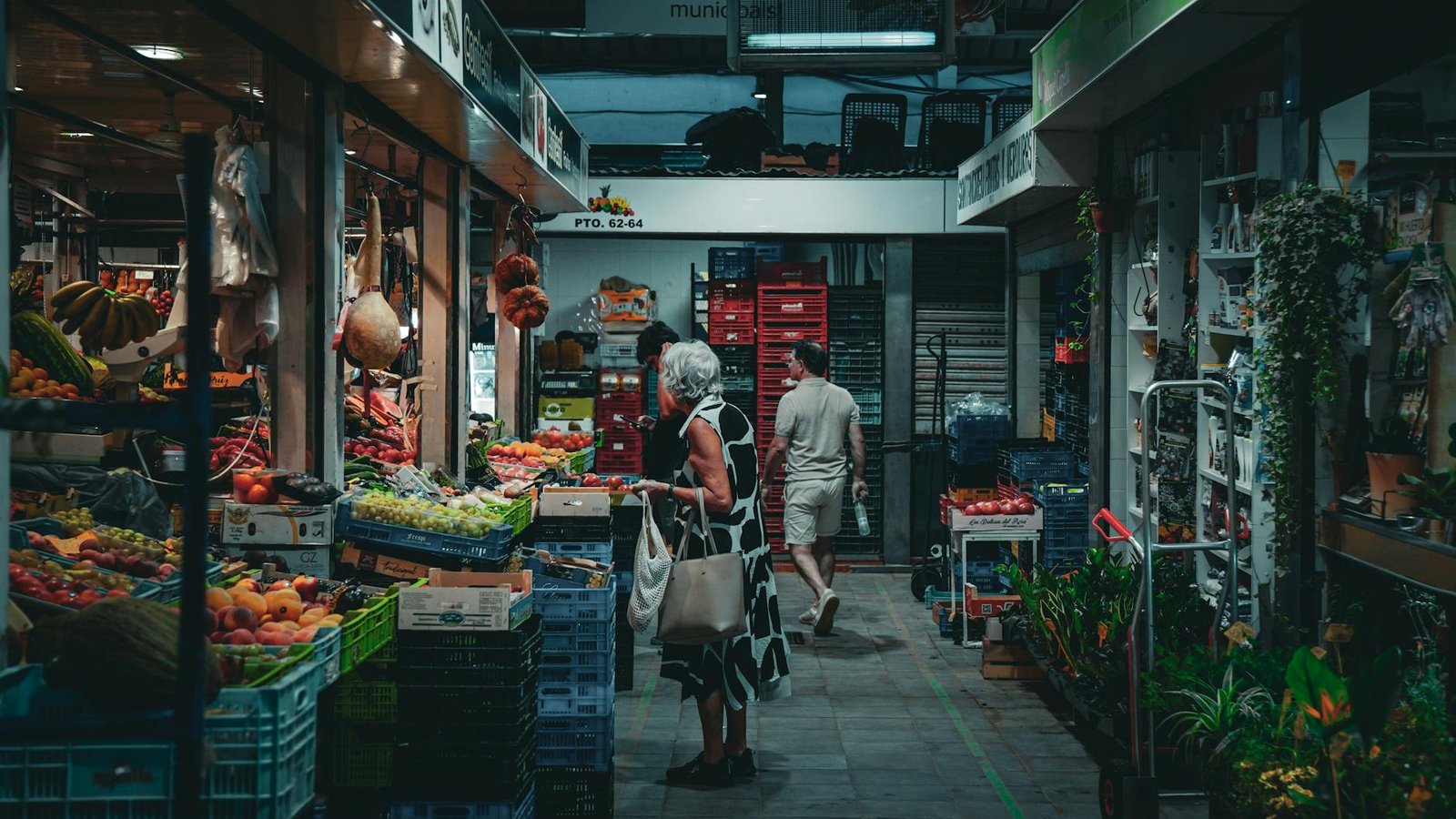 Vibrant market in Balearic Islands with diverse produce and shoppers exploring.