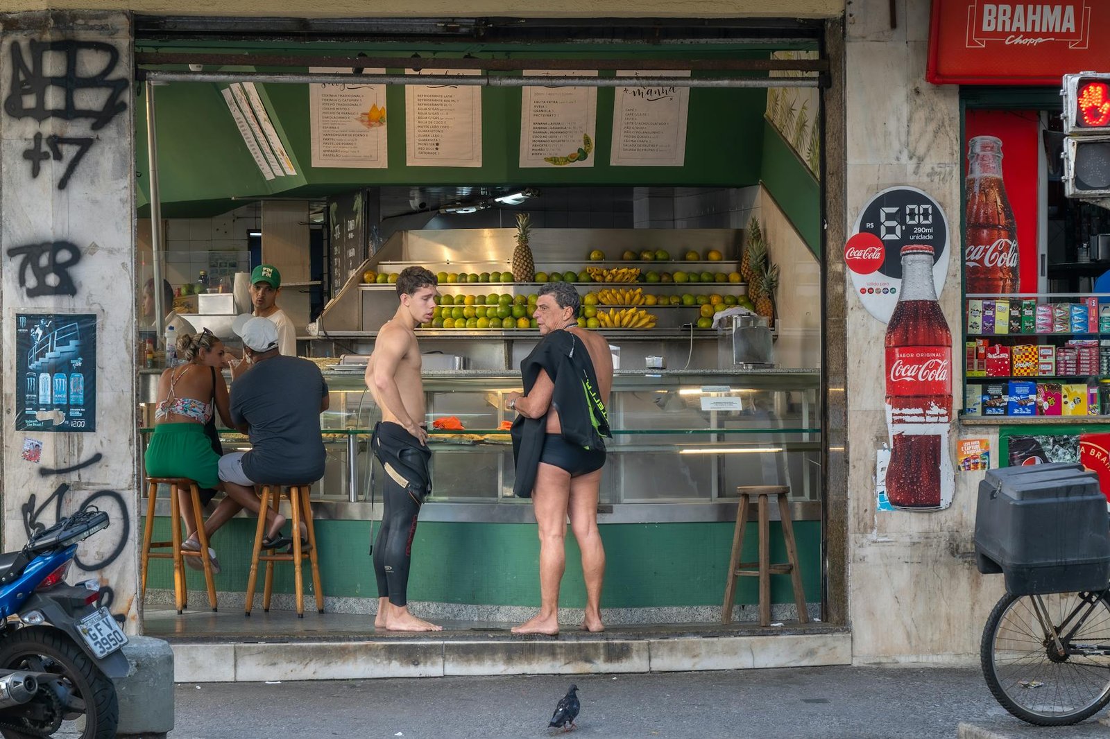 People enjoying fresh juice at a local bar in Rio de Janeiro's vibrant streets.
