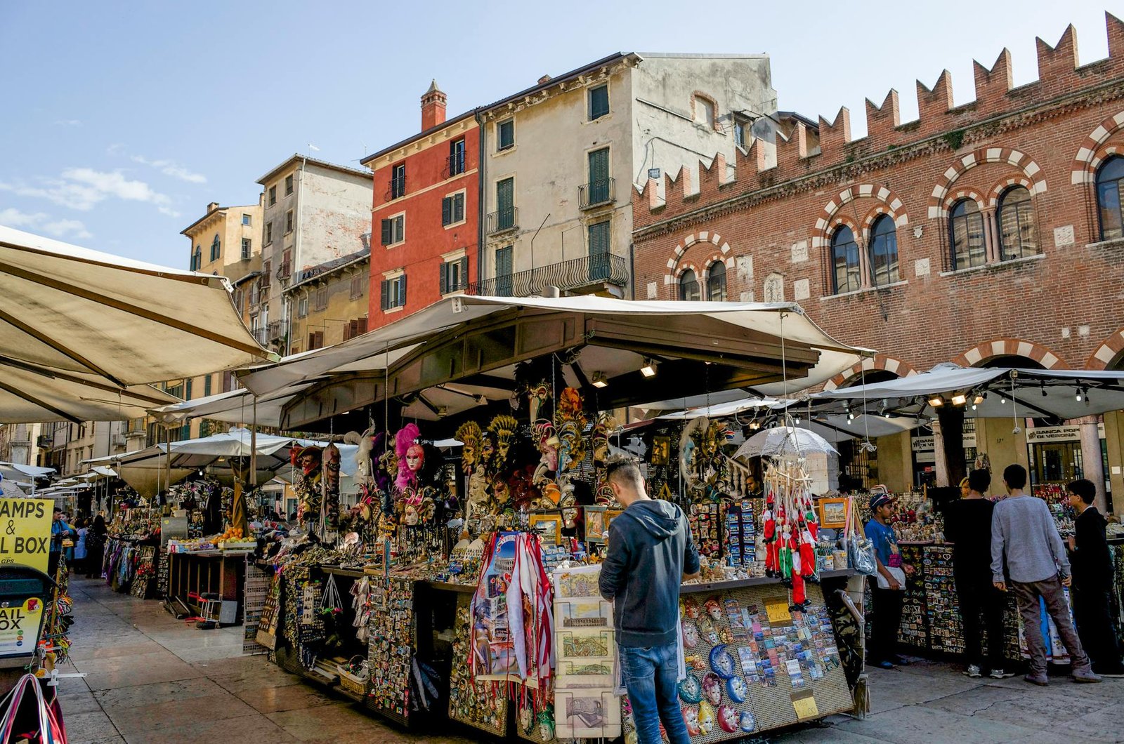 Lively street market scene in Verona, showcasing local crafts and architecture.