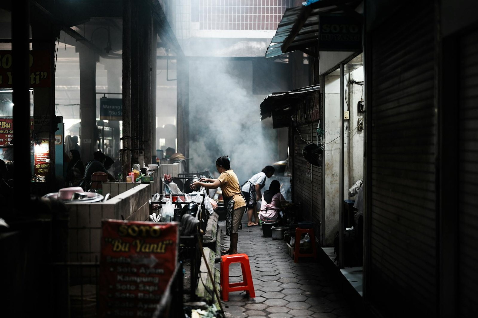 Capturing the vibrant atmosphere of a street food market in Jogja, Indonesia, with smoky cooking action.