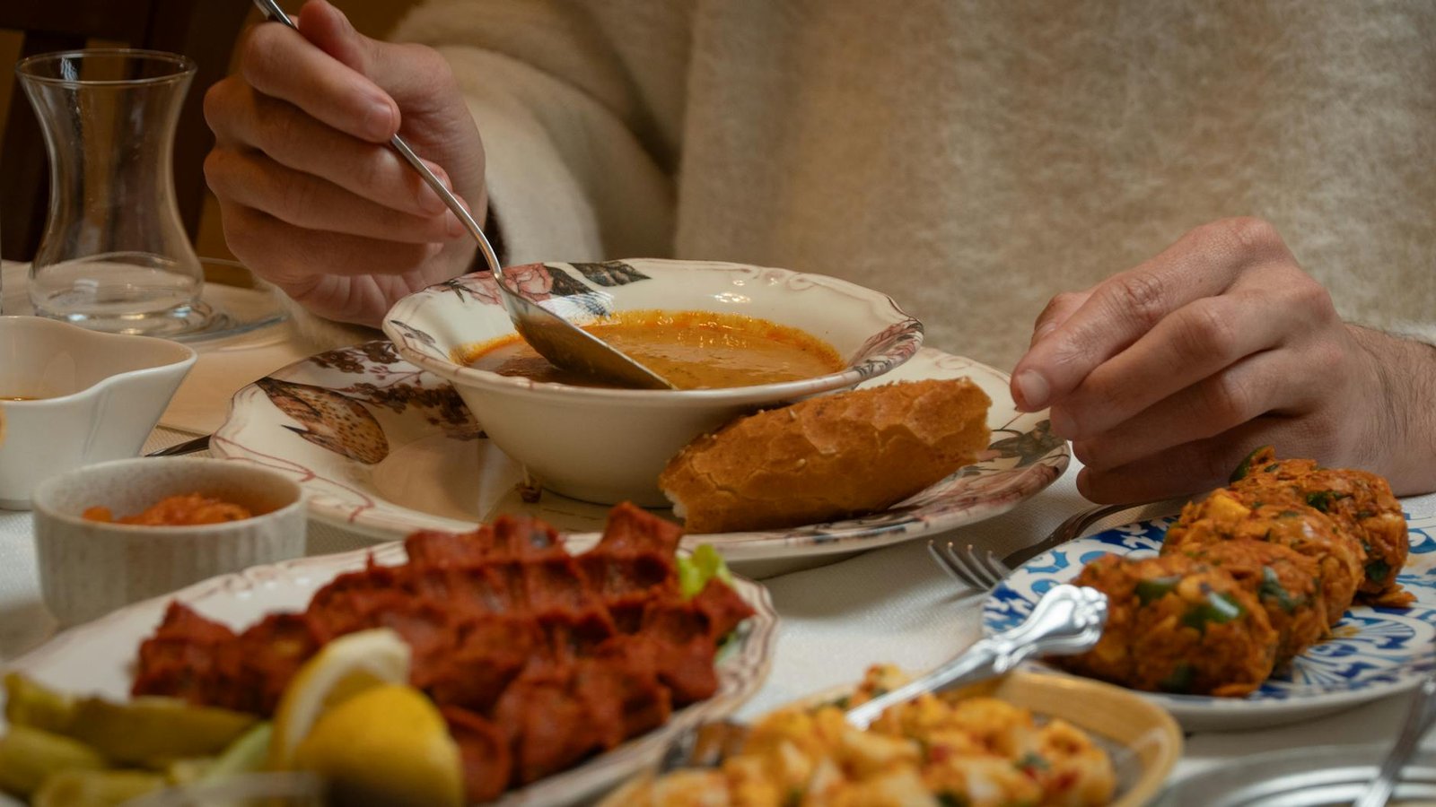 Traditional Turkish meal with soup, bread, and appetizers in Gaziantep.