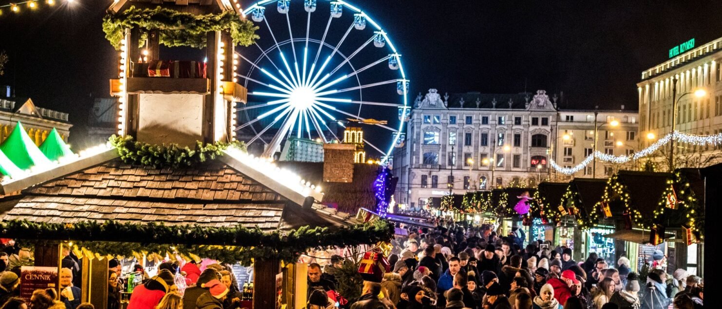 Christmas market at night with a ferris wheel