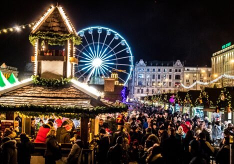 Christmas market at night with a ferris wheel
