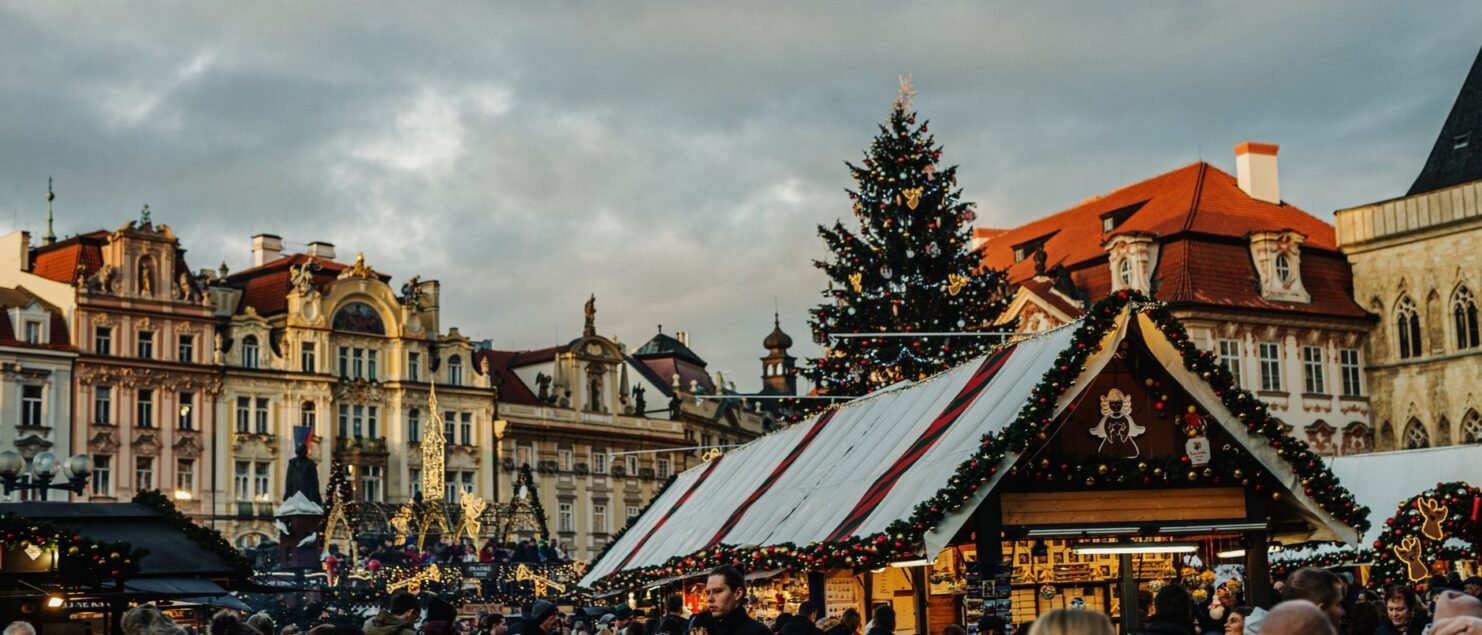 Christmas market stalls and tree on Prague Old Town Square