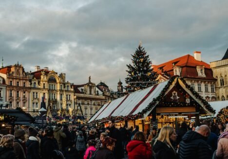 Christmas market stalls and tree on Prague Old Town Square